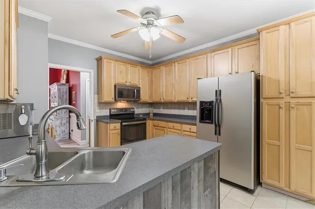 a kitchen with stainless steel appliances a chandelier and a refrigerator