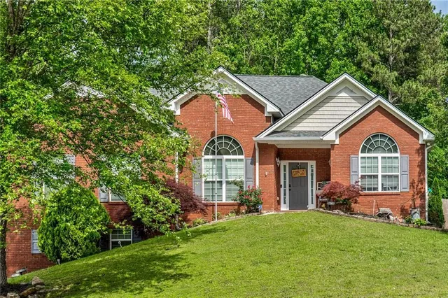 a front view of a house with garden