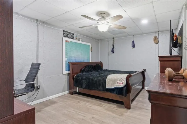 a living room with furniture a flat screen tv and kitchen view