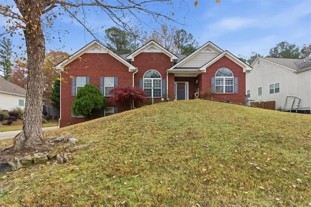 a front view of a house with a yard