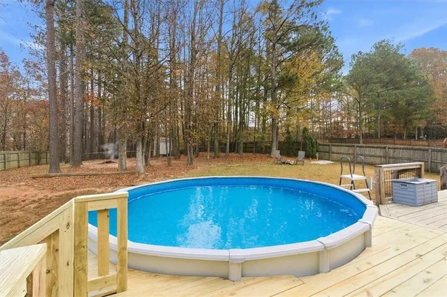 a front view of a house with swimming pool and porch