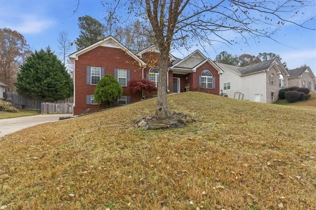 a front view of a house with a yard