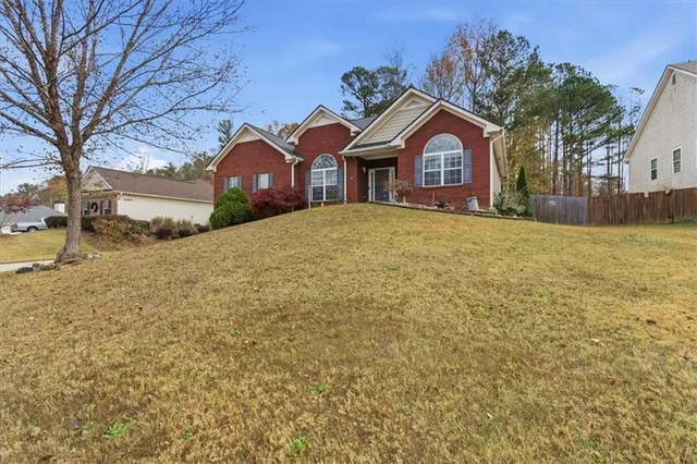 a front view of a house with a yard