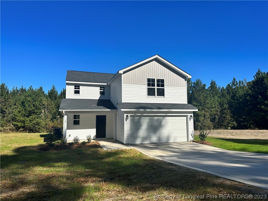 757 Britt Road St. Pauls, NC 28384 - Photo 1 of 25 a front view of a house with a yard and garage