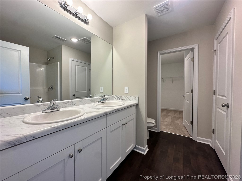 757 Britt Road St. Pauls, NC 28384 - Photo 11 of 25 a bathroom with a double vanity sink and a mirror