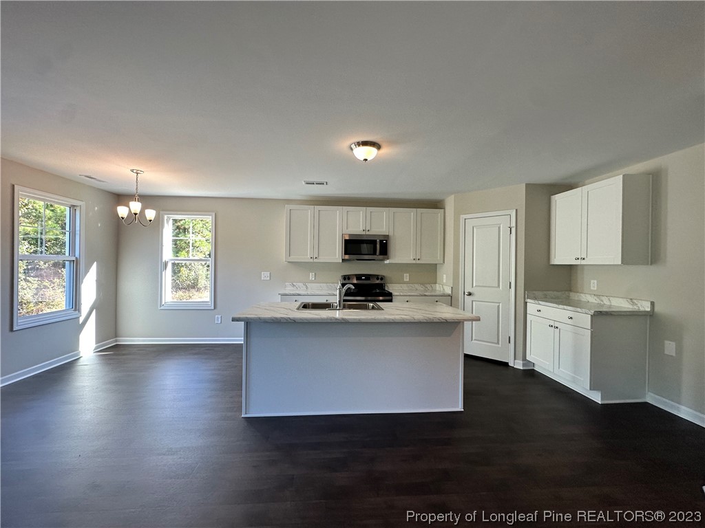 757 Britt Road St. Pauls, NC 28384 - Photo 3 of 25 a kitchen with a stove a sink and a refrigerator