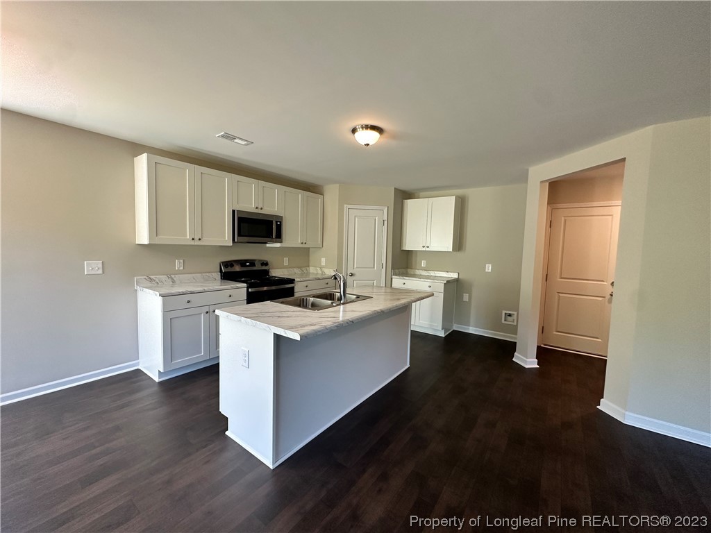 757 Britt Road St. Pauls, NC 28384 - Photo 4 of 25 a kitchen with a sink and a stove top oven