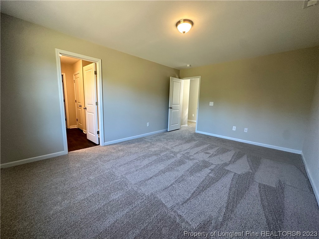 757 Britt Road St. Pauls, NC 28384 - Photo 9 of 25 a view of an empty room with wooden floor