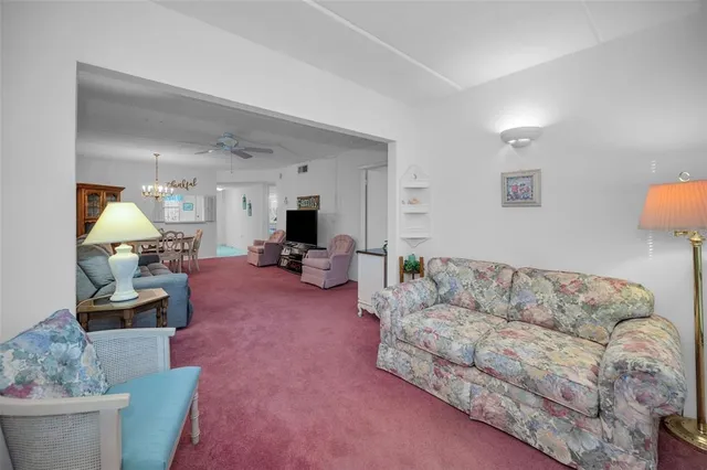 a dining room with furniture a chandelier and window