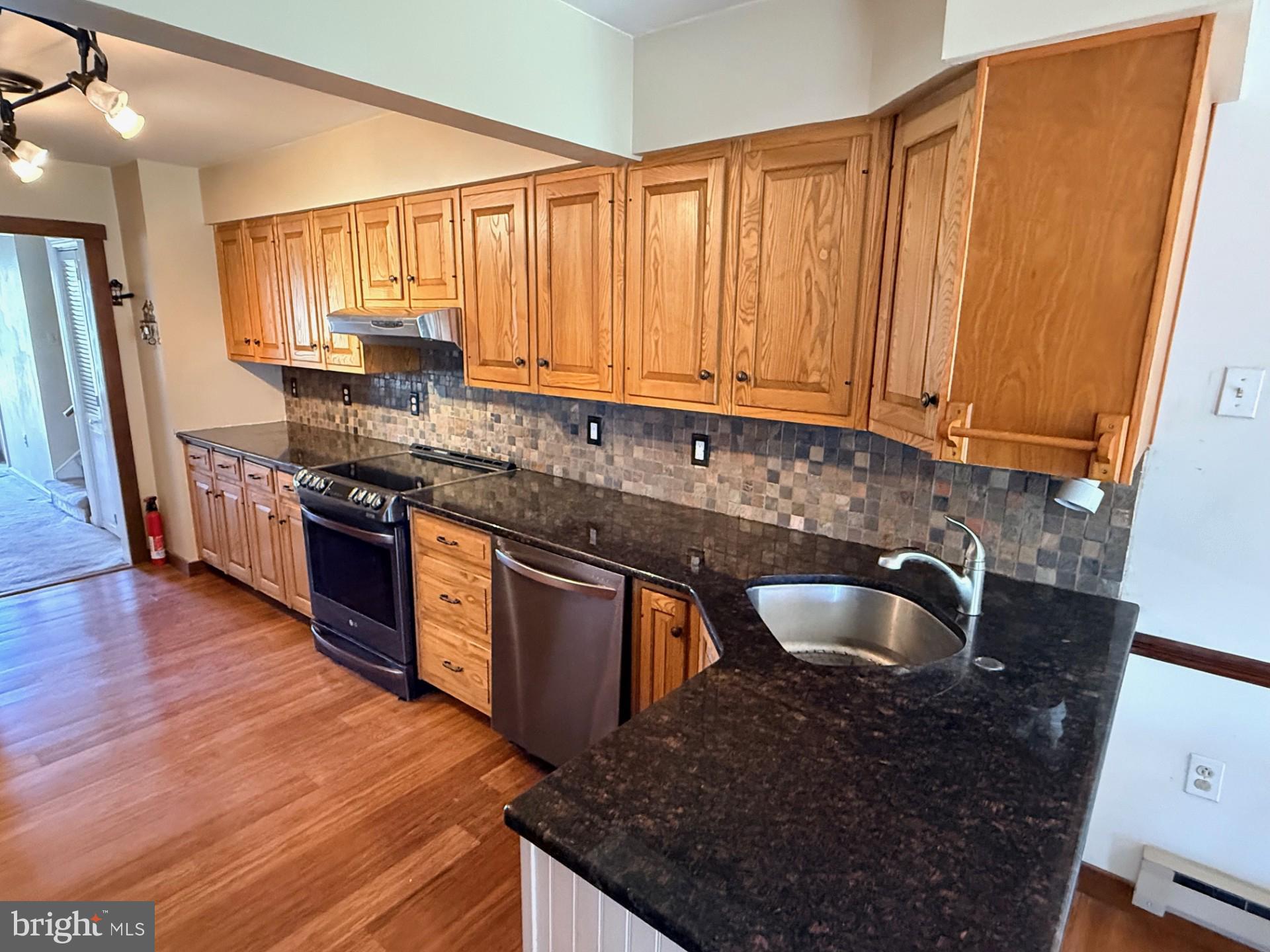 1831 Jill Road Willow Grove, PA 19090 - Photo 12 of 35 a kitchen with stainless steel appliances granite countertop a sink stove and cabinets