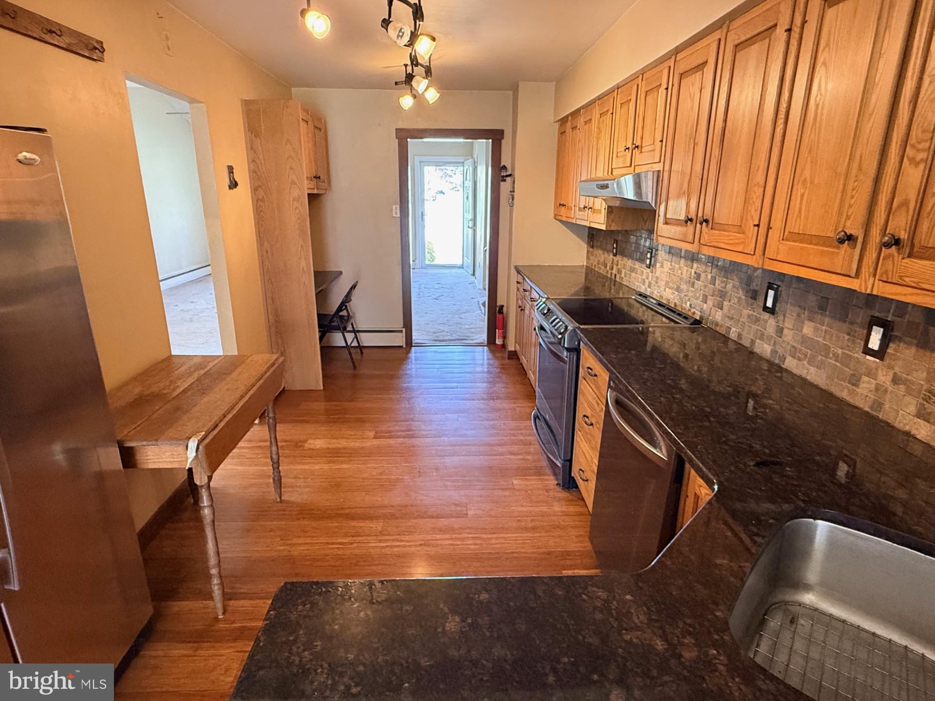 1831 Jill Road Willow Grove, PA 19090 - Photo 13 of 35 a view of a kitchen with kitchen island dining table and wooden floor