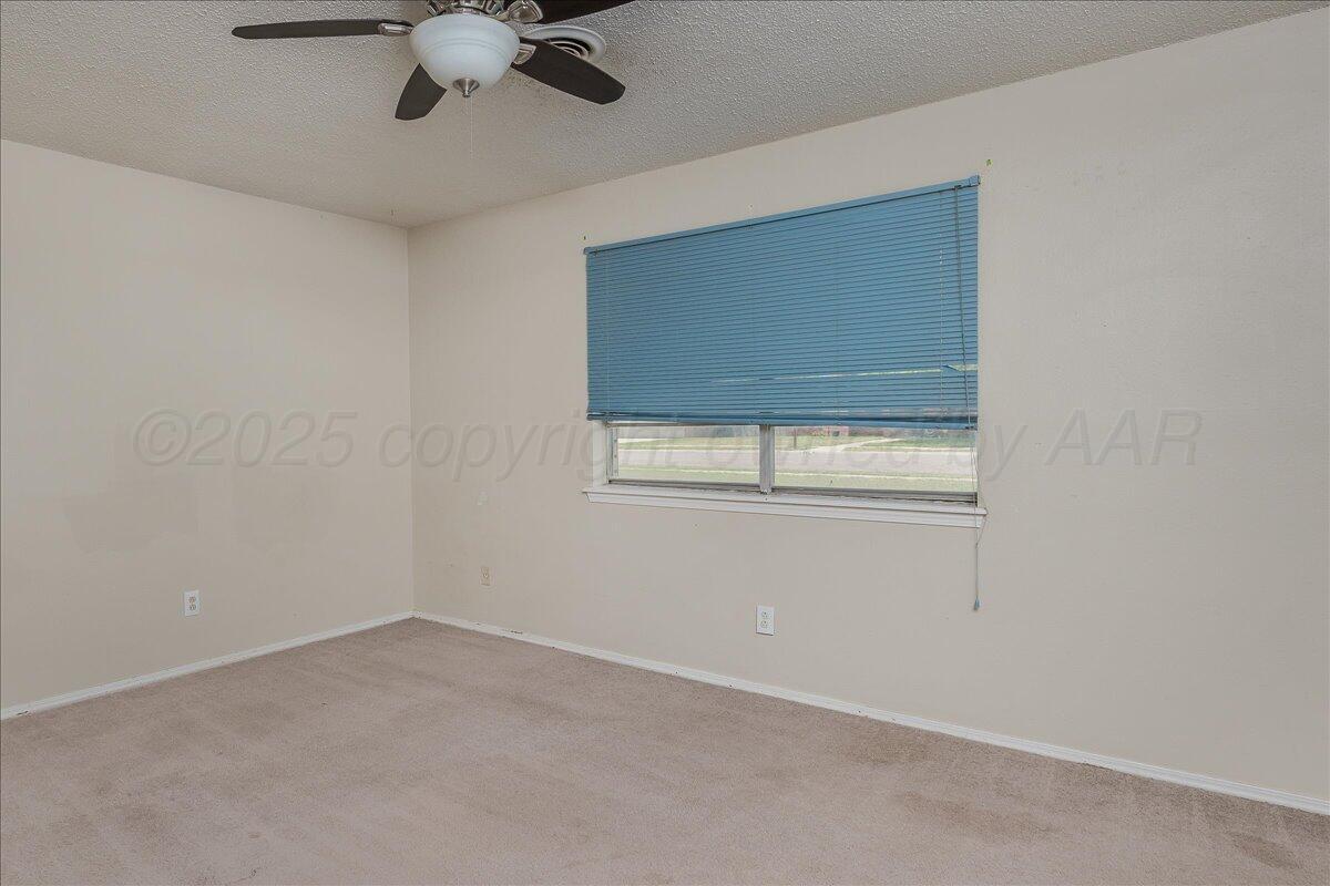 7209 Hatton Road Amarillo, TX 79110 - Photo 12 of 16 a view of an empty room with a window
