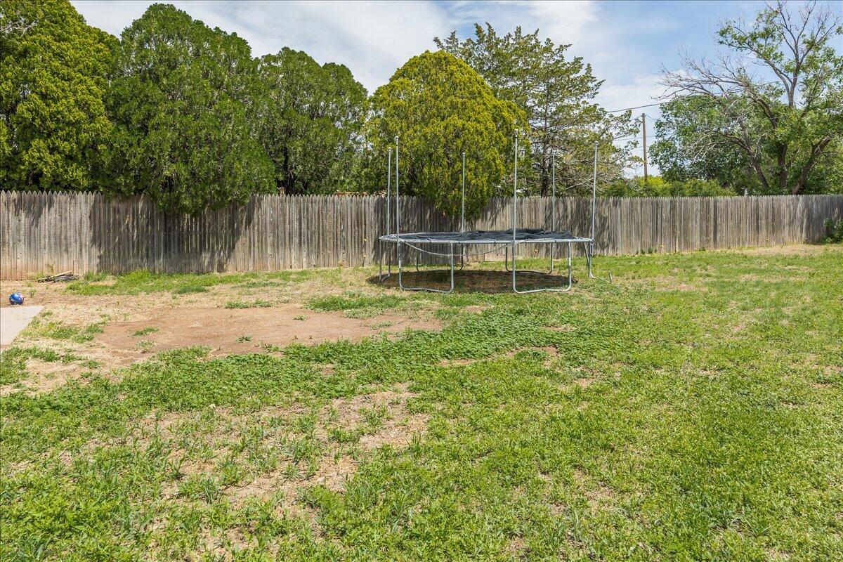 7209 Hatton Road Amarillo, TX 79110 - Photo 16 of 16 a backyard of a house with table and chairs a wooden fence