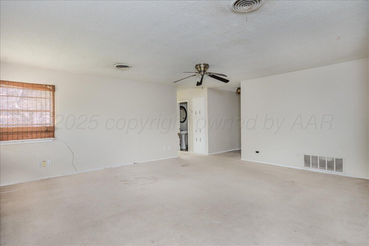 7209 Hatton Road Amarillo, TX 79110 - Photo 5 of 16 an empty room with windows and closet