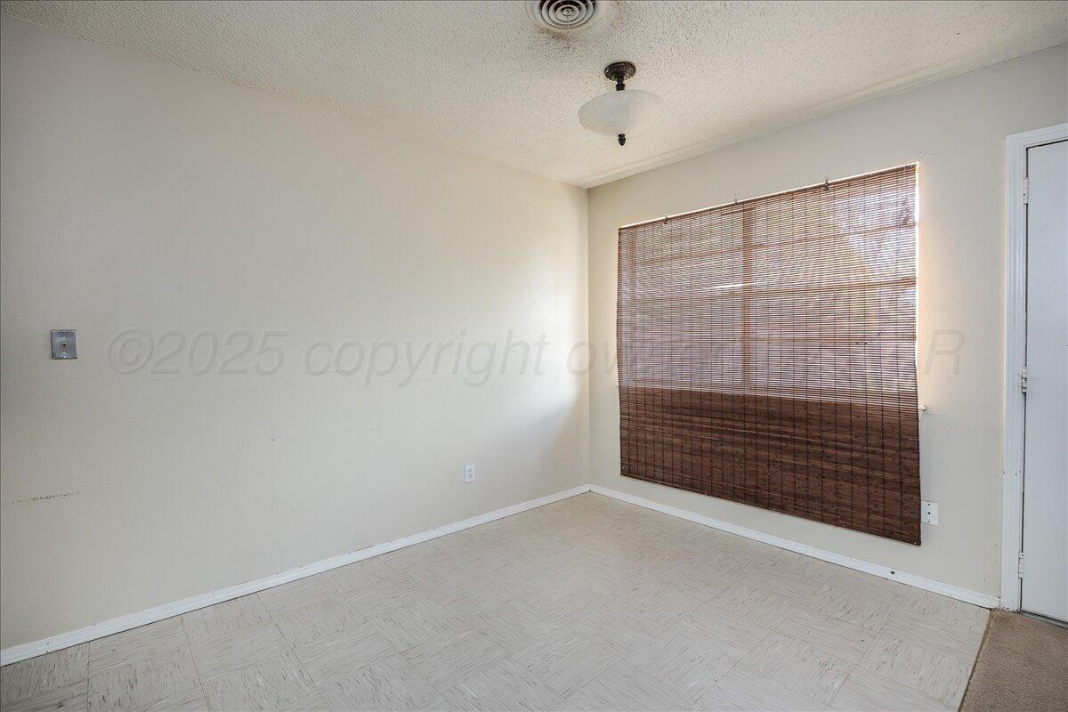 7209 Hatton Road Amarillo, TX 79110 - Photo 6 of 16 a view of an empty room with cabinet and fan