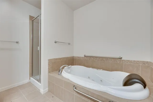 a bathroom with a bathtub and shower