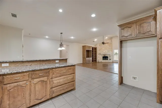 a open kitchen with kitchen island a sink dishwasher stove with cabinets and entryway
