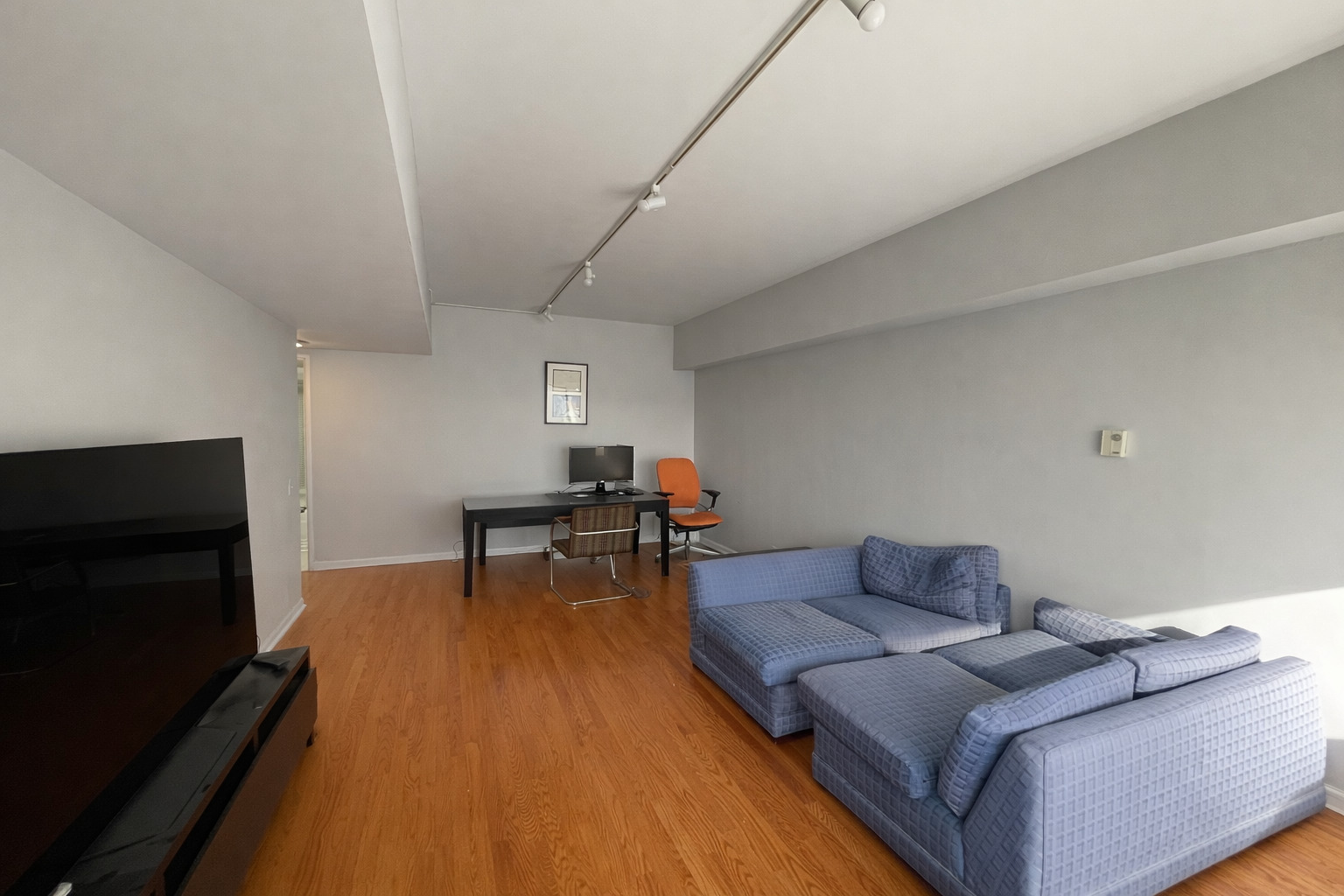 175 East Delaware Place, Unit 6114 Chicago, IL 60611 - Photo 7 of 16 a living room with furniture and a flat screen tv