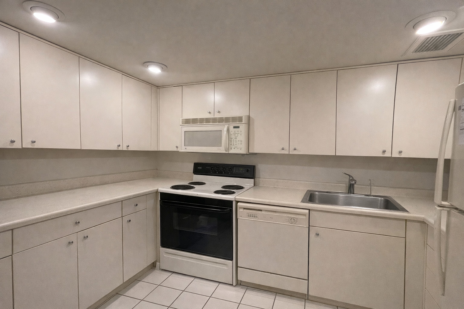 175 East Delaware Place, Unit 6114 Chicago, IL 60611 - Photo 8 of 16 a kitchen with white cabinets appliances and sink