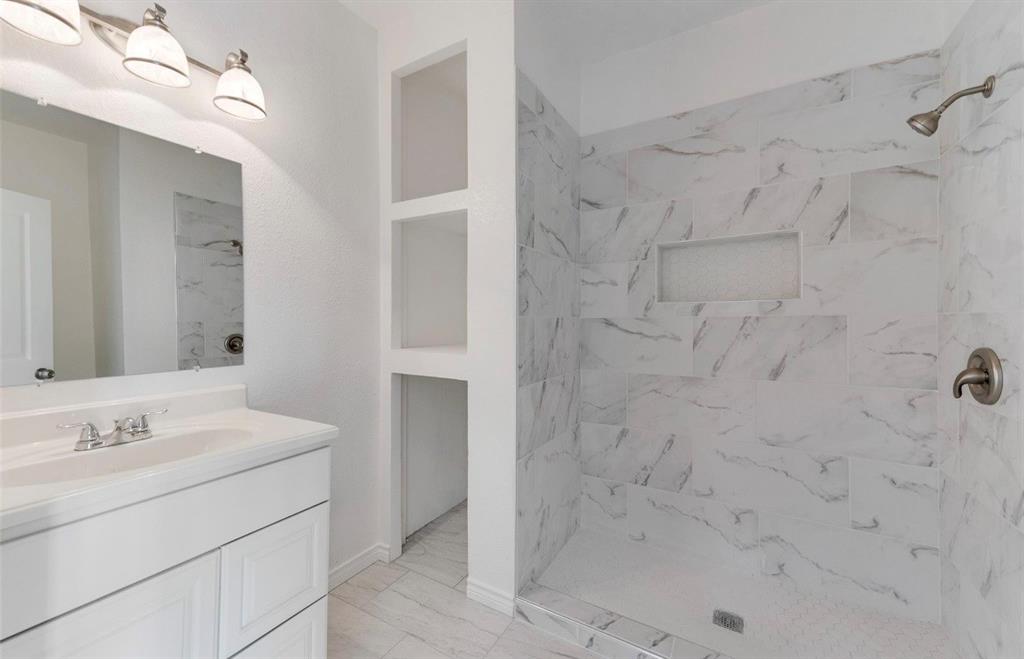 2003 Walnut Street Greenville, TX 75401 - Photo 11 of 18 a bathroom with a sink shower and a mirror