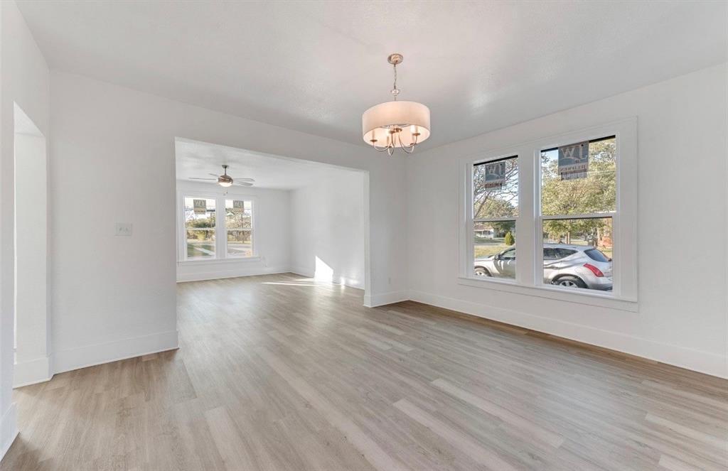 2003 Walnut Street Greenville, TX 75401 - Photo 12 of 18 an empty room with wooden floor and window