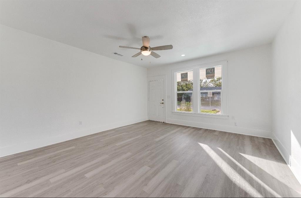 2003 Walnut Street Greenville, TX 75401 - Photo 4 of 18 wooden floor in an empty room with a window