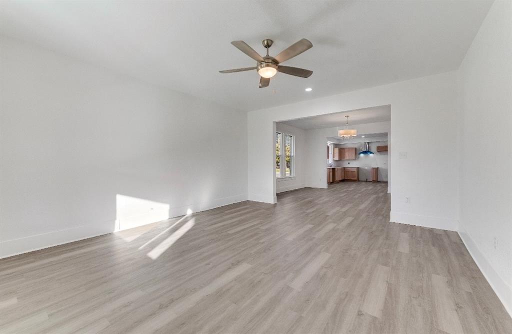 2003 Walnut Street Greenville, TX 75401 - Photo 6 of 18 a view of a livingroom with a hardwood floor and a ceiling fan
