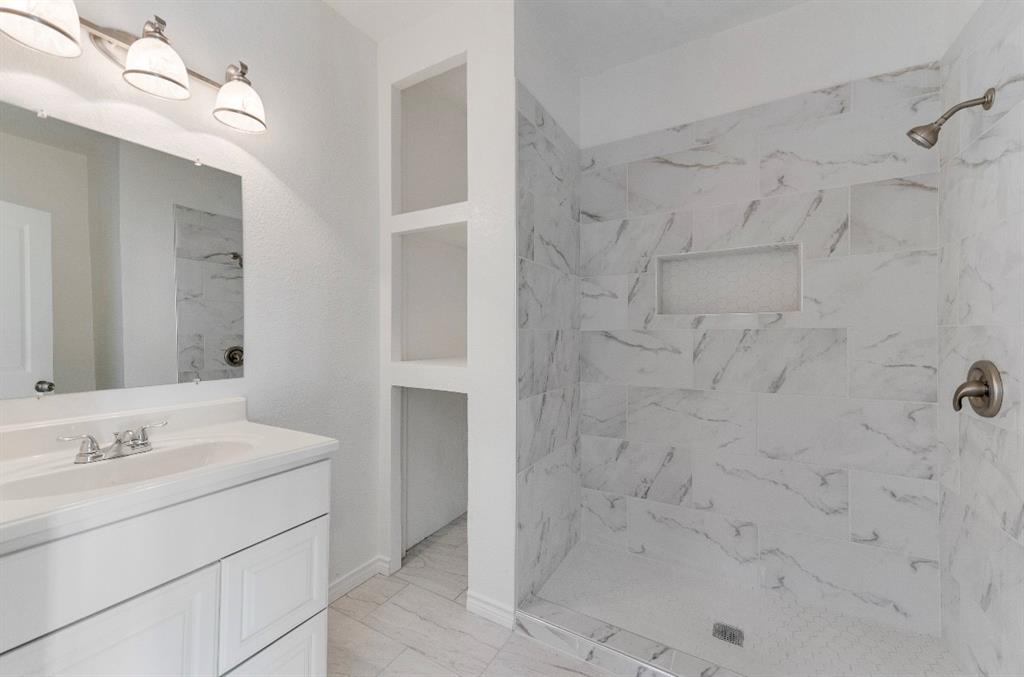 2003 Walnut Street Greenville, TX 75401 - Photo 7 of 18 a bathroom with a sink and a mirror