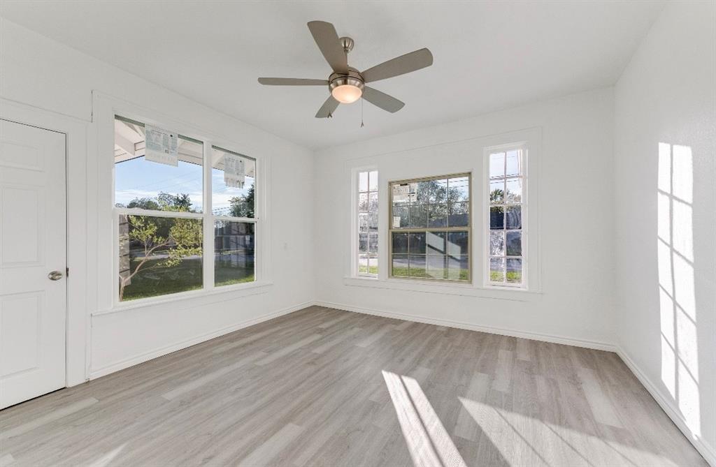 2003 Walnut Street Greenville, TX 75401 - Photo 8 of 18 a view of an empty room with a window and wooden floor