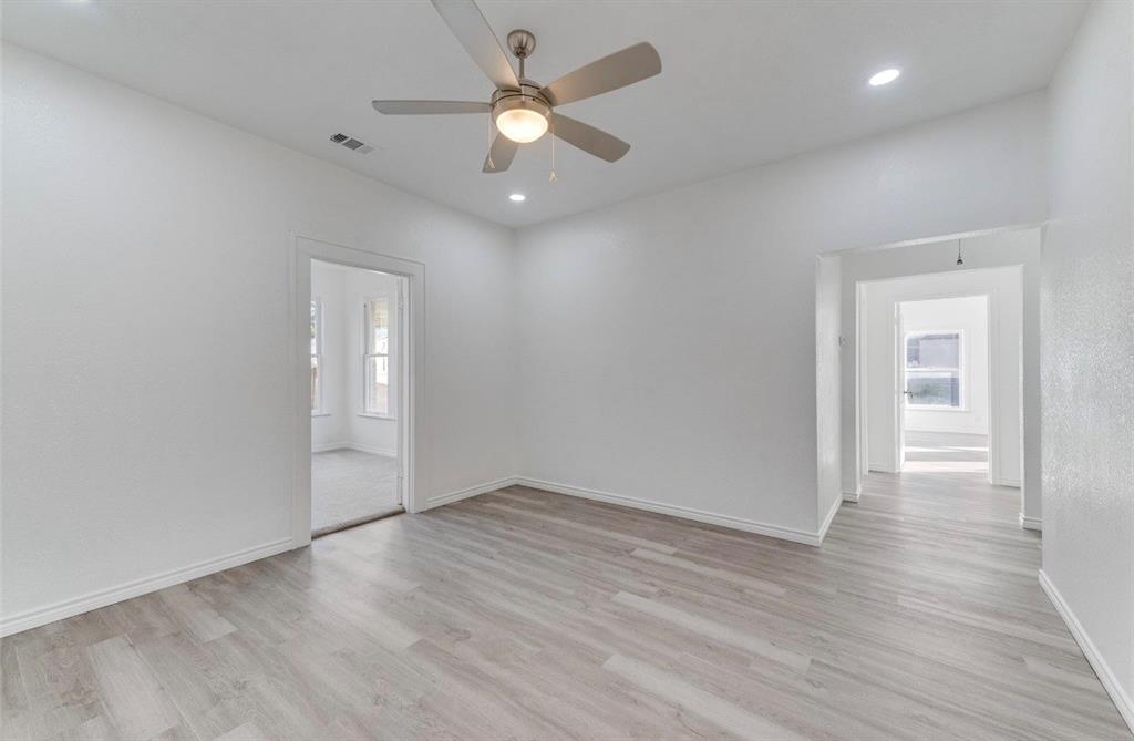 2003 Walnut Street Greenville, TX 75401 - Photo 9 of 18 wooden floor in an empty room with a window