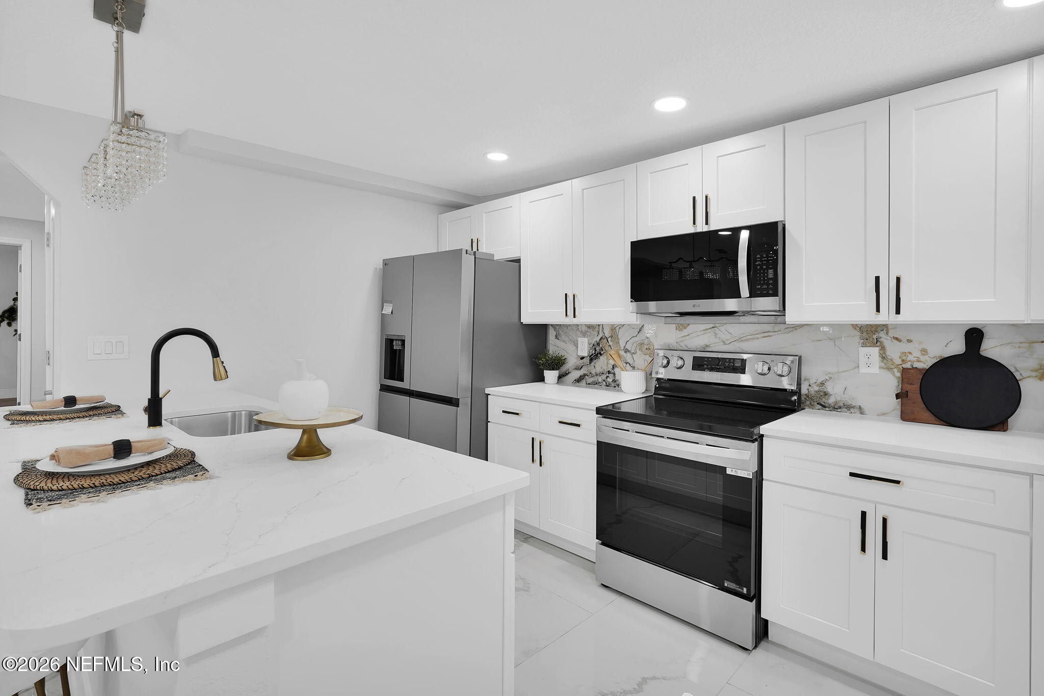 3946 Murrhee Road Green Cove Springs, FL 32043 - Photo 14 of 35 a kitchen with a sink stainless steel appliances and white cabinets