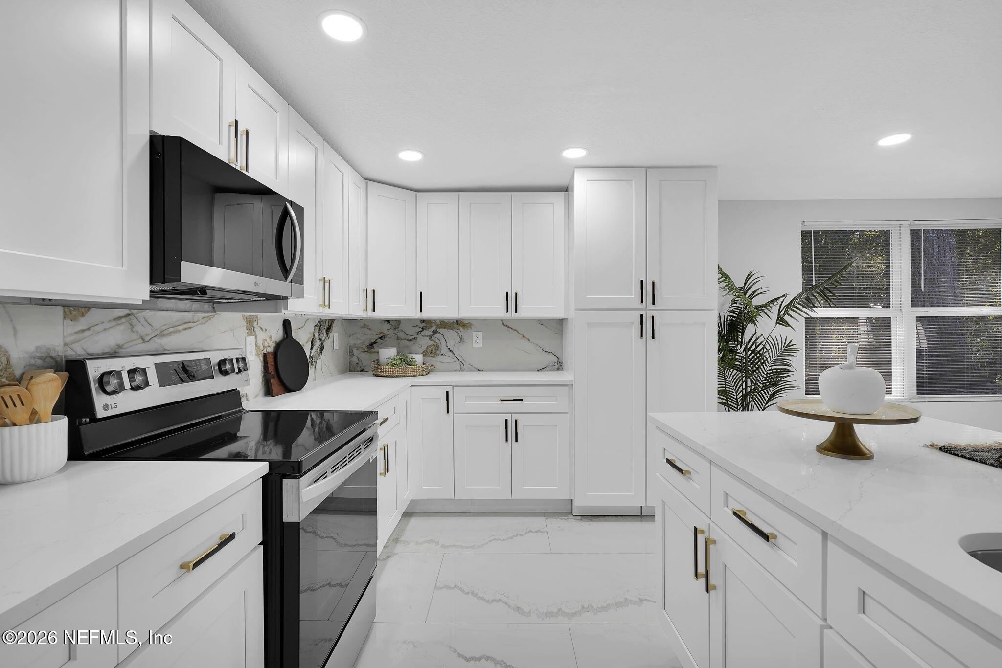 3946 Murrhee Road Green Cove Springs, FL 32043 - Photo 15 of 35 a kitchen with a sink a stove and cabinets