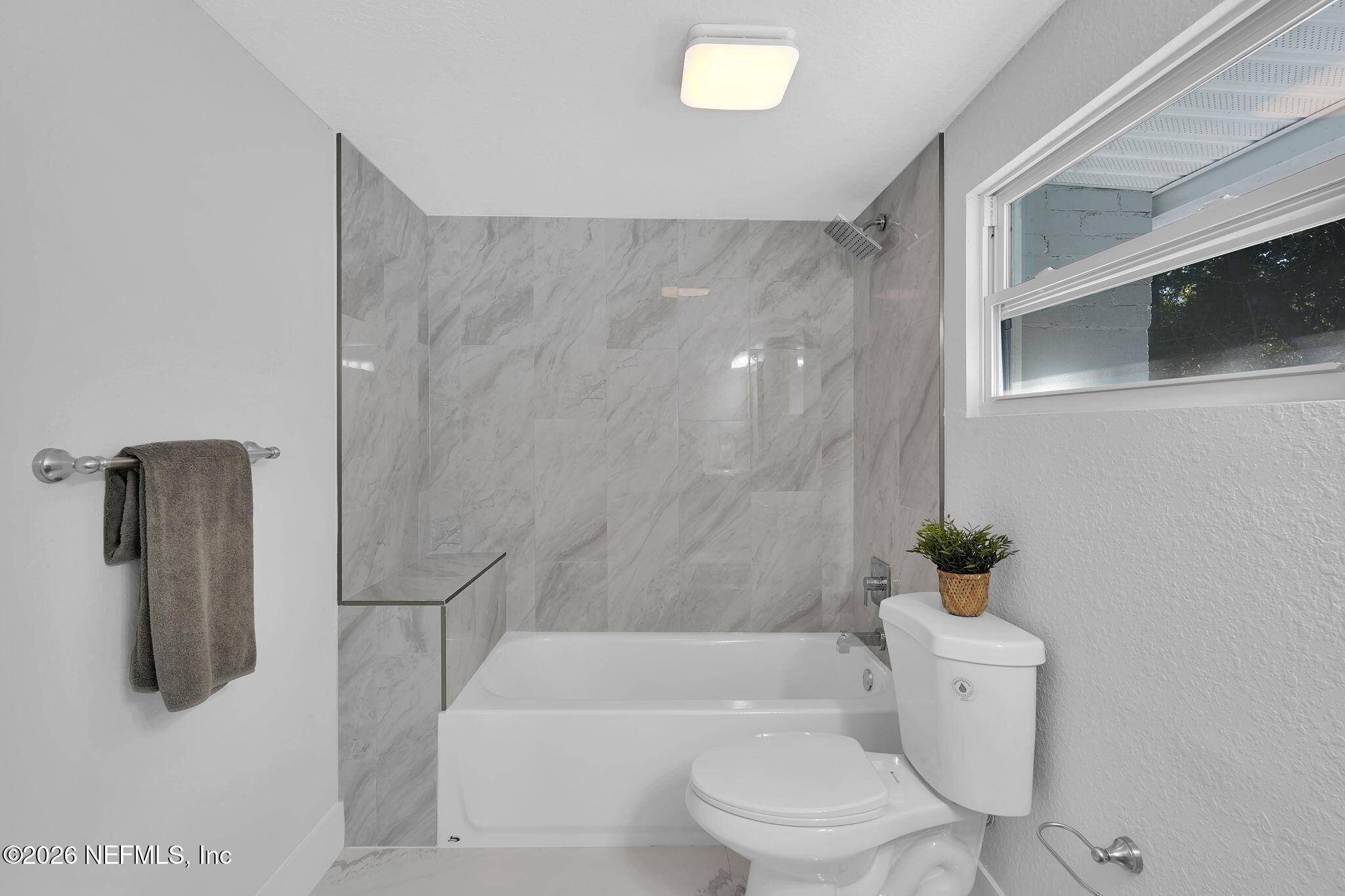 3946 Murrhee Road Green Cove Springs, FL 32043 - Photo 19 of 35 a white toilet sitting next to a bathroom sink and tub