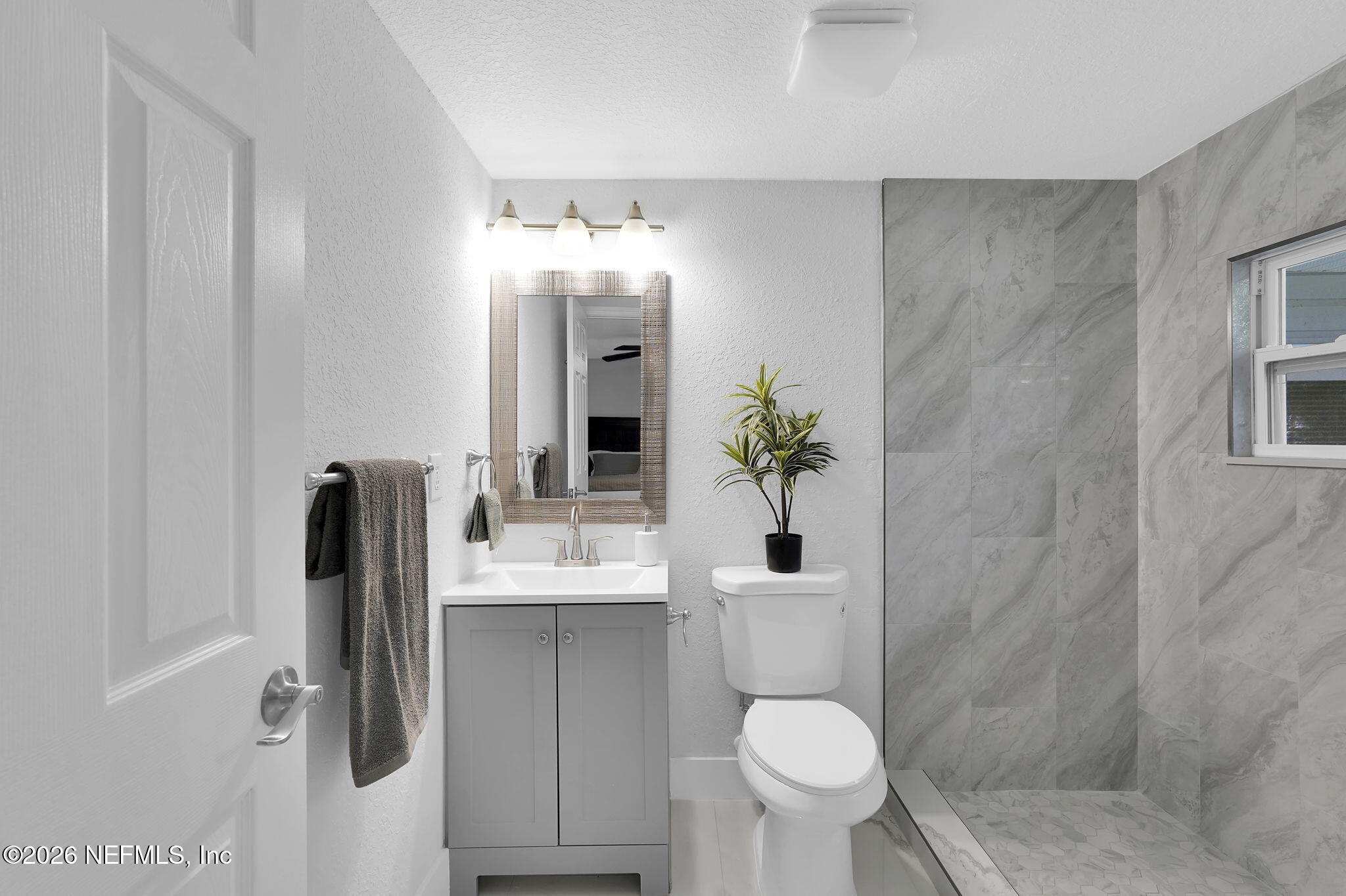 3946 Murrhee Road Green Cove Springs, FL 32043 - Photo 26 of 35 a bathroom with a sink toilet and mirror