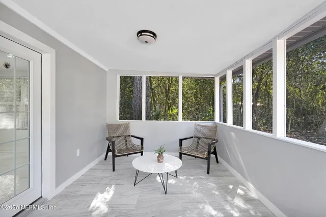 a view of a room with a chairs and table in a room