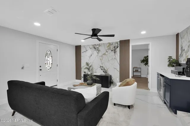 a living room with furniture and a large mirror