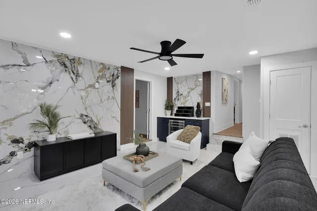 a living room with furniture and kitchen view