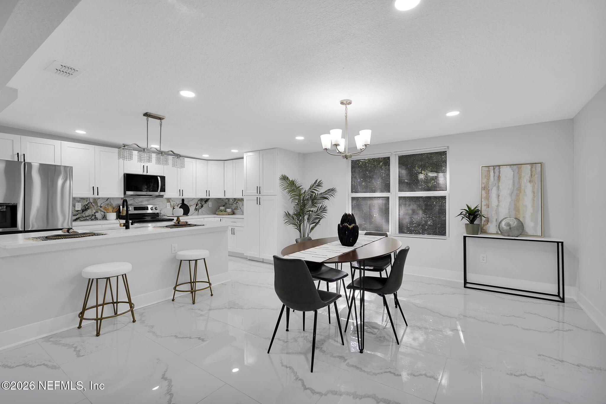 3946 Murrhee Road Green Cove Springs, FL 32043 - Photo 10 of 35 a view of a dining room with furniture and a kitchen view