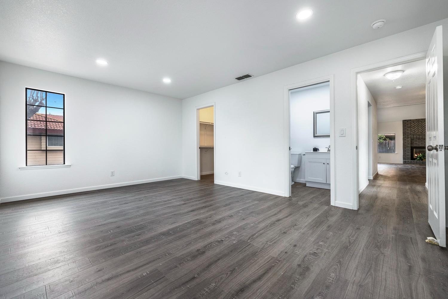 929 Barnett Way Madera, CA 93637 - Photo 15 of 23 a view of a big room with wooden floors and a bathroom