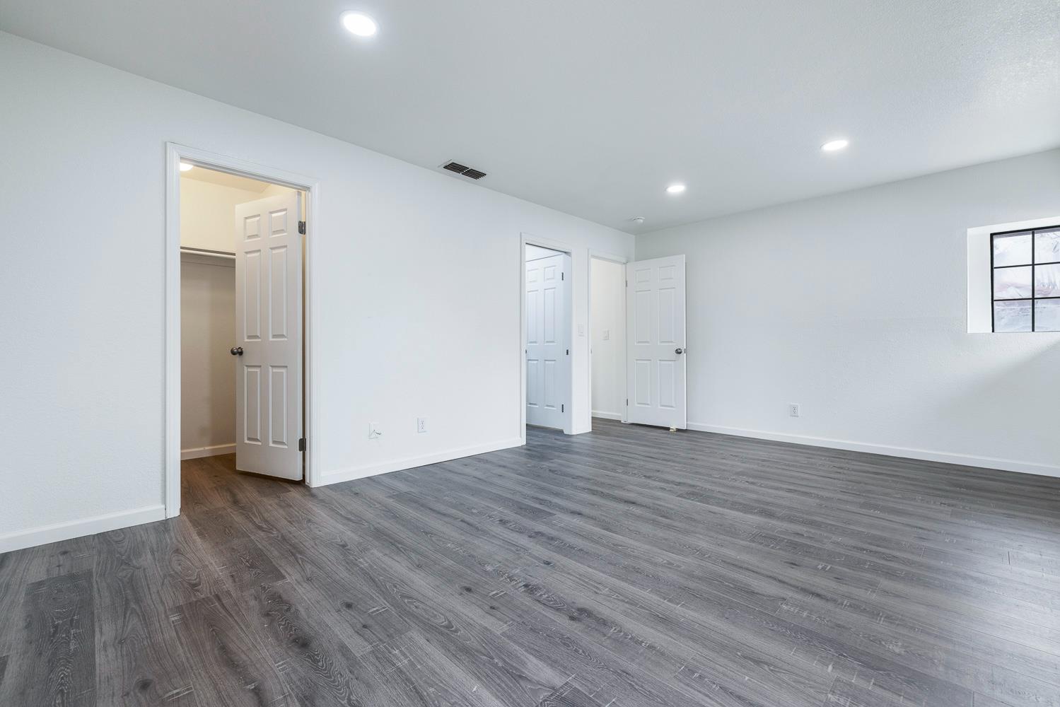 929 Barnett Way Madera, CA 93637 - Photo 17 of 23 a view of an empty room with wooden floor and closet