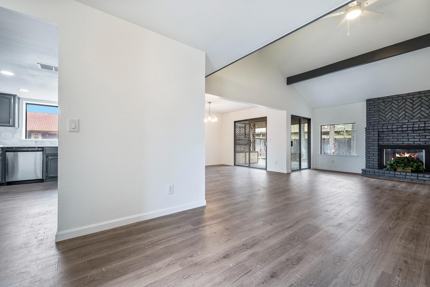 929 Barnett Way Madera, CA 93637 - Photo 2 of 23 a view of a livingroom with wooden floor and a fireplace
