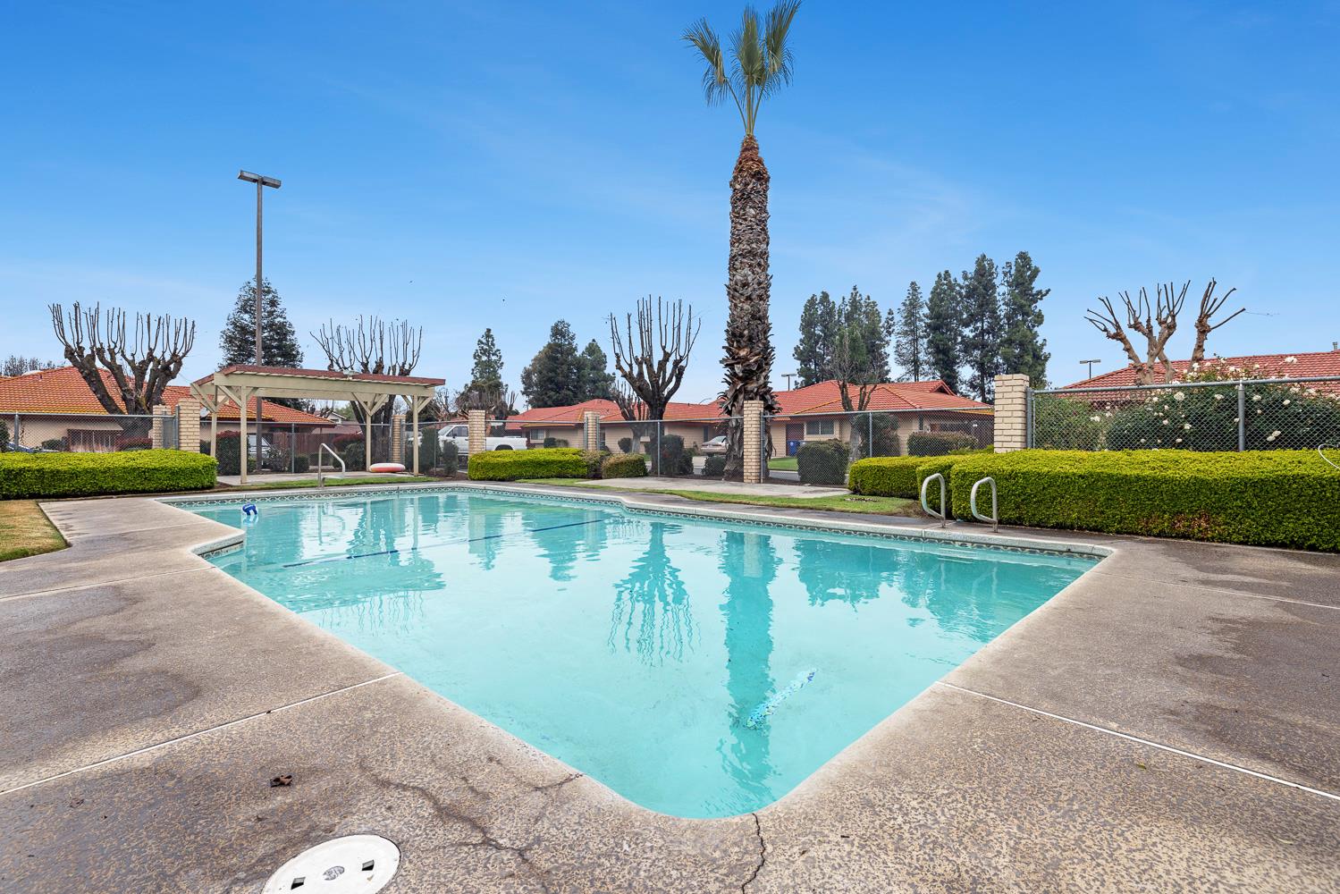 929 Barnett Way Madera, CA 93637 - Photo 23 of 23 a view of a lake with a fountain and a wooden bridge