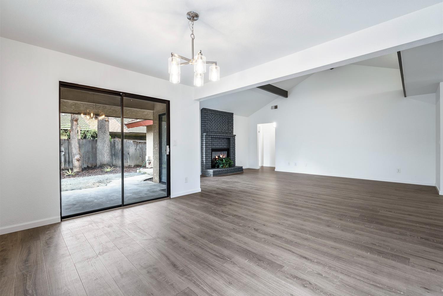929 Barnett Way Madera, CA 93637 - Photo 6 of 23 a view of a livingroom with wooden floor a ceiling fan and window