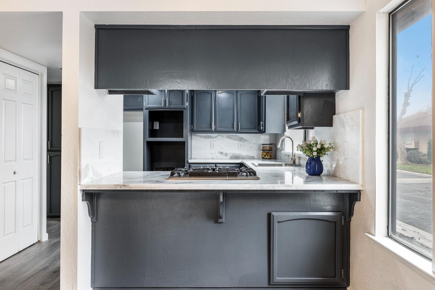 929 Barnett Way Madera, CA 93637 - Photo 8 of 23 a kitchen with stainless steel appliances a sink and cabinets