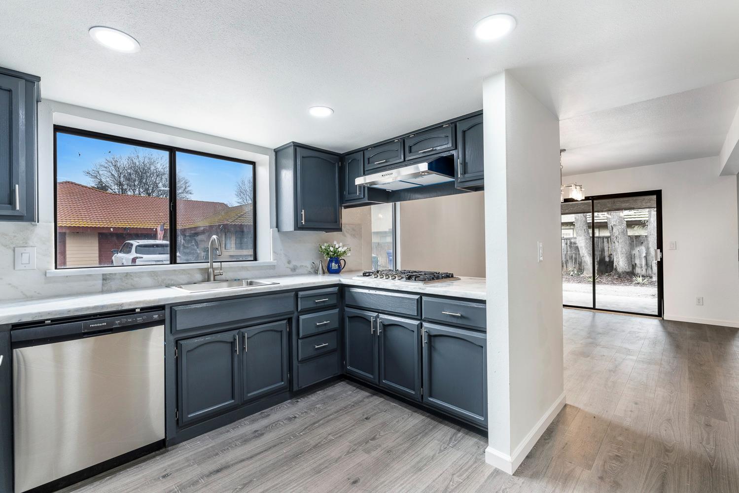 929 Barnett Way Madera, CA 93637 - Photo 10 of 23 a kitchen with wooden cabinets and white appliances