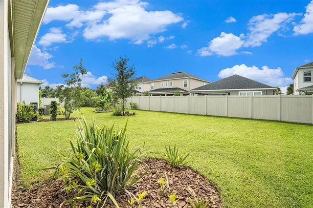 a swimming pool with outdoor seating and yard