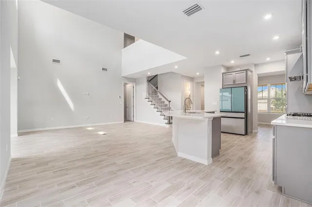 a view of kitchen and hall with wooden floor
