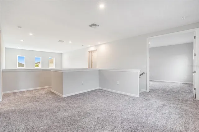 an empty room with a empty space and windows