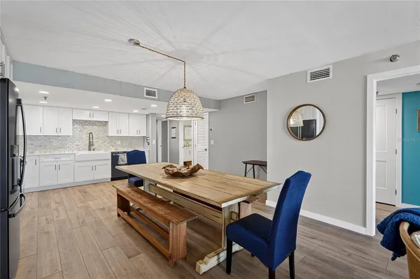 a view of a dining room with furniture and wooden floor