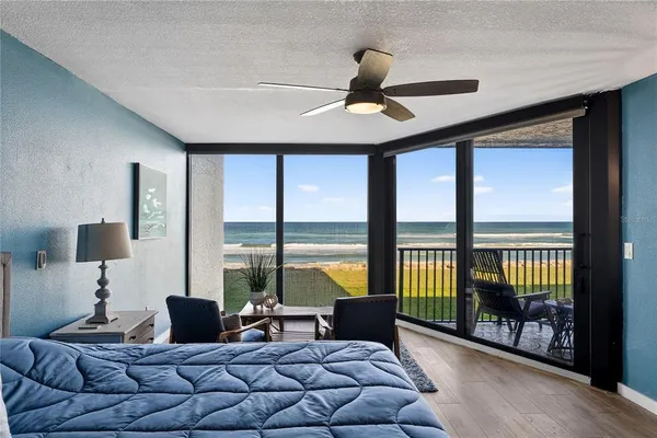 a living room with furniture and a floor to ceiling window